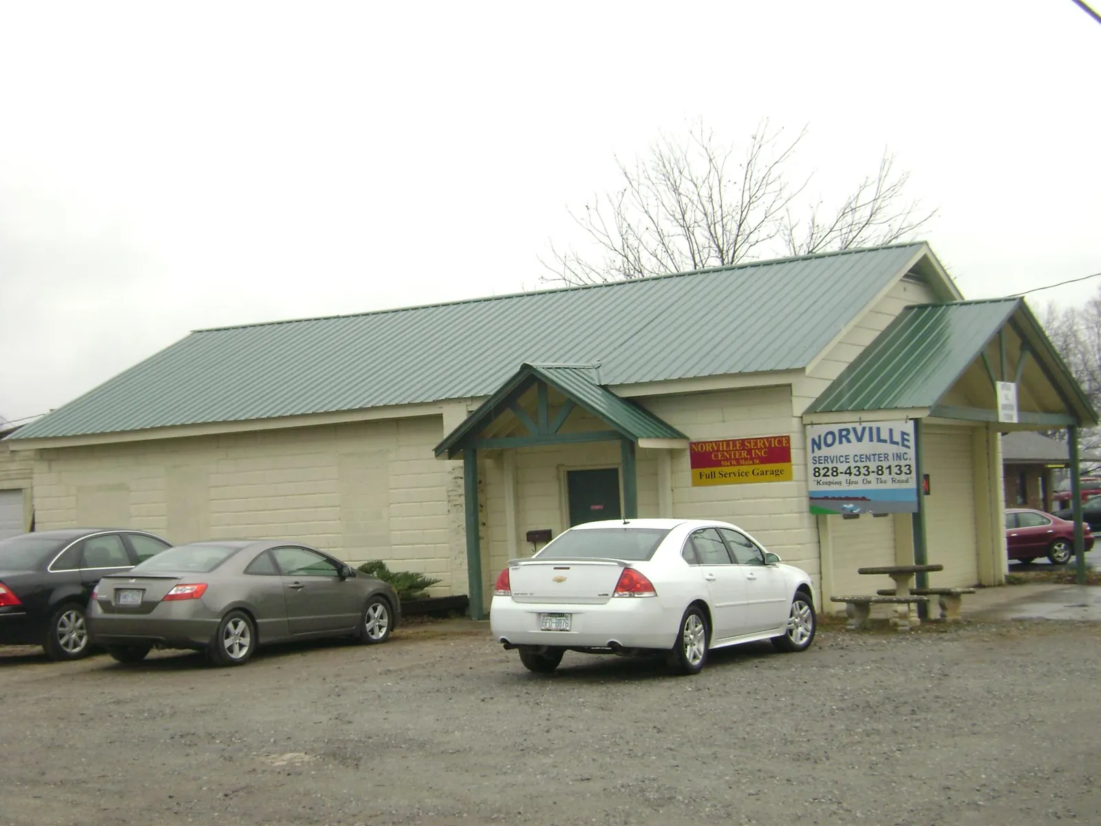 Green metal roof on a service garage with a covered entry in East Freetown
