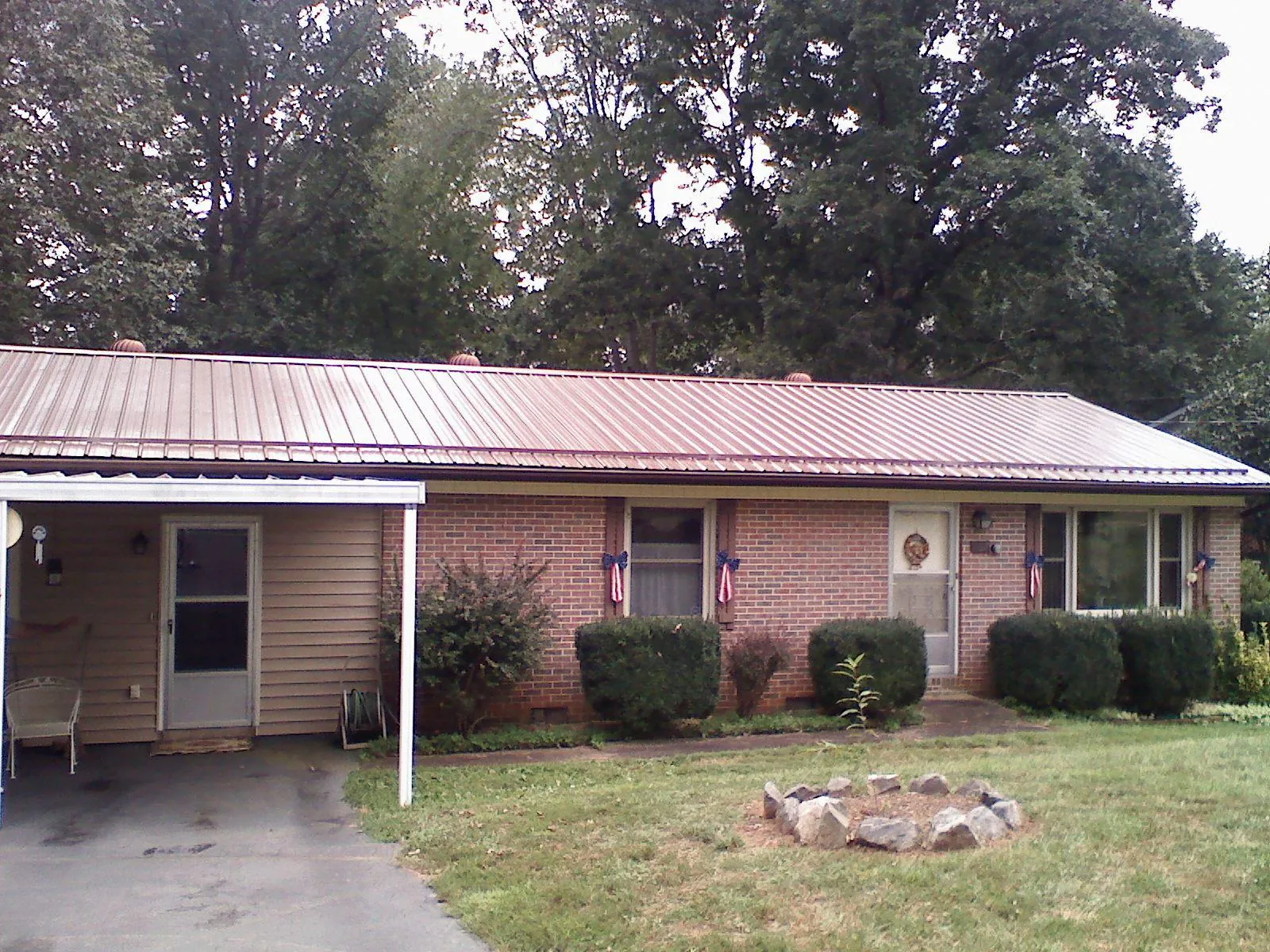 Bronze metal roof and carport on a brick ranch home — Roof Repair work by our crew in East Freetown